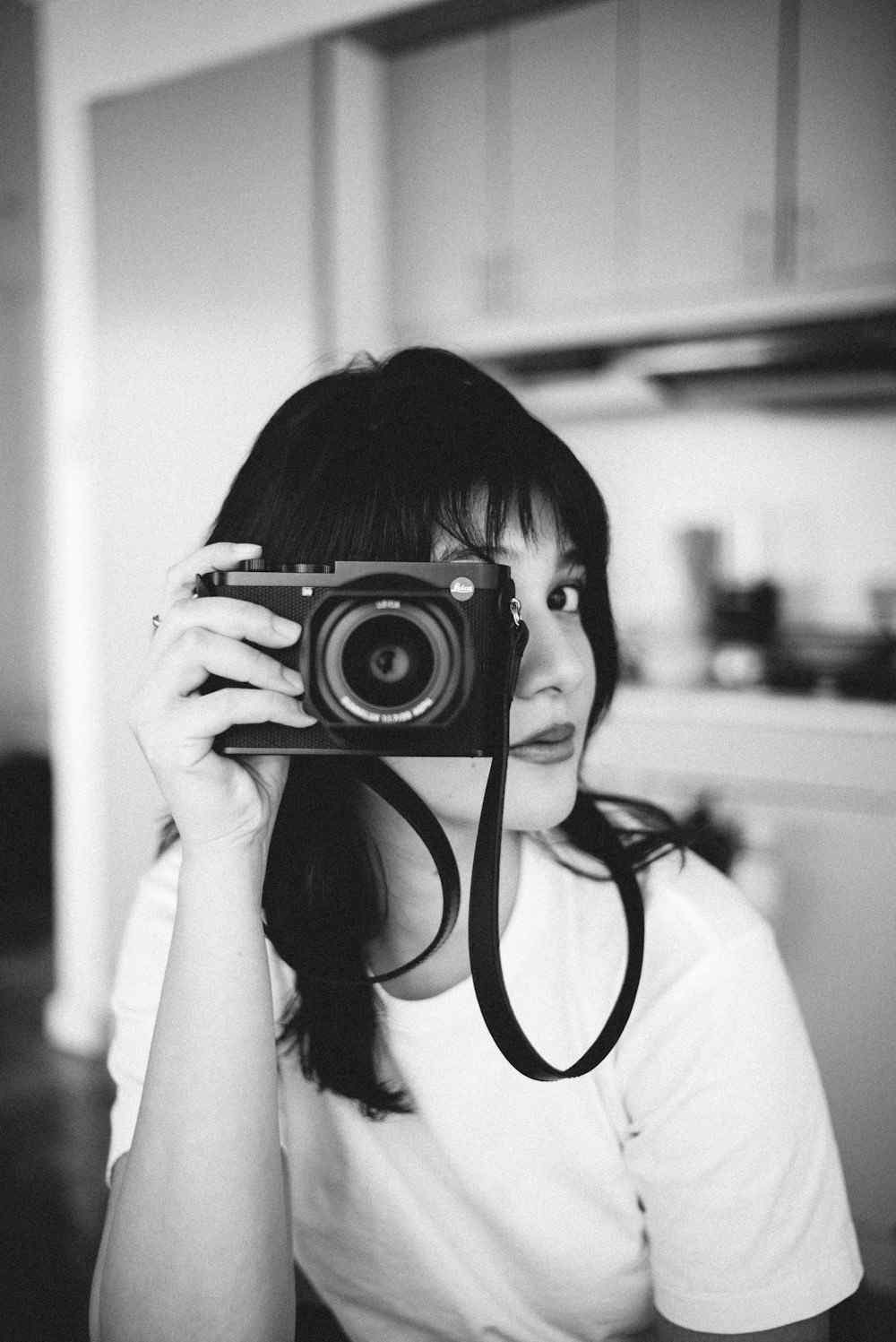 Asila, the photographer, framing a shot with her camera