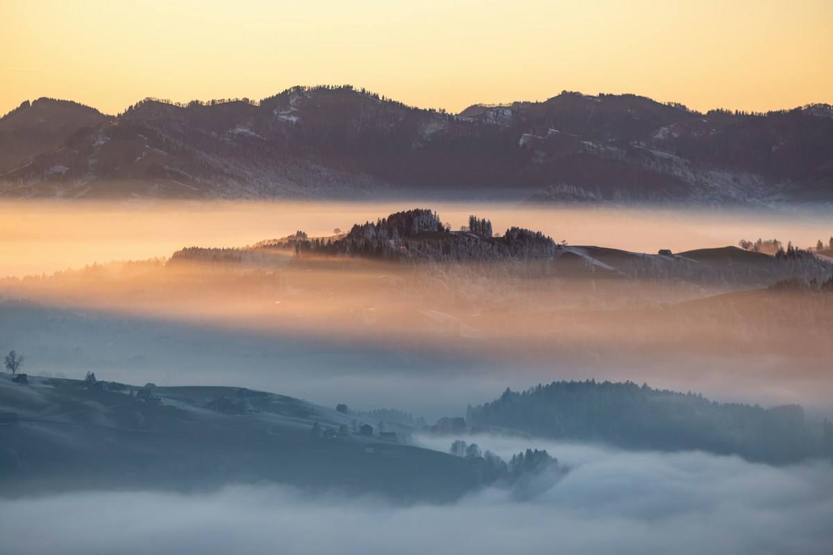 Mountains above a sea of cloud at sunrise