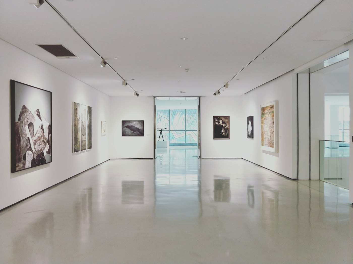 A bright gallery hung with photographs
