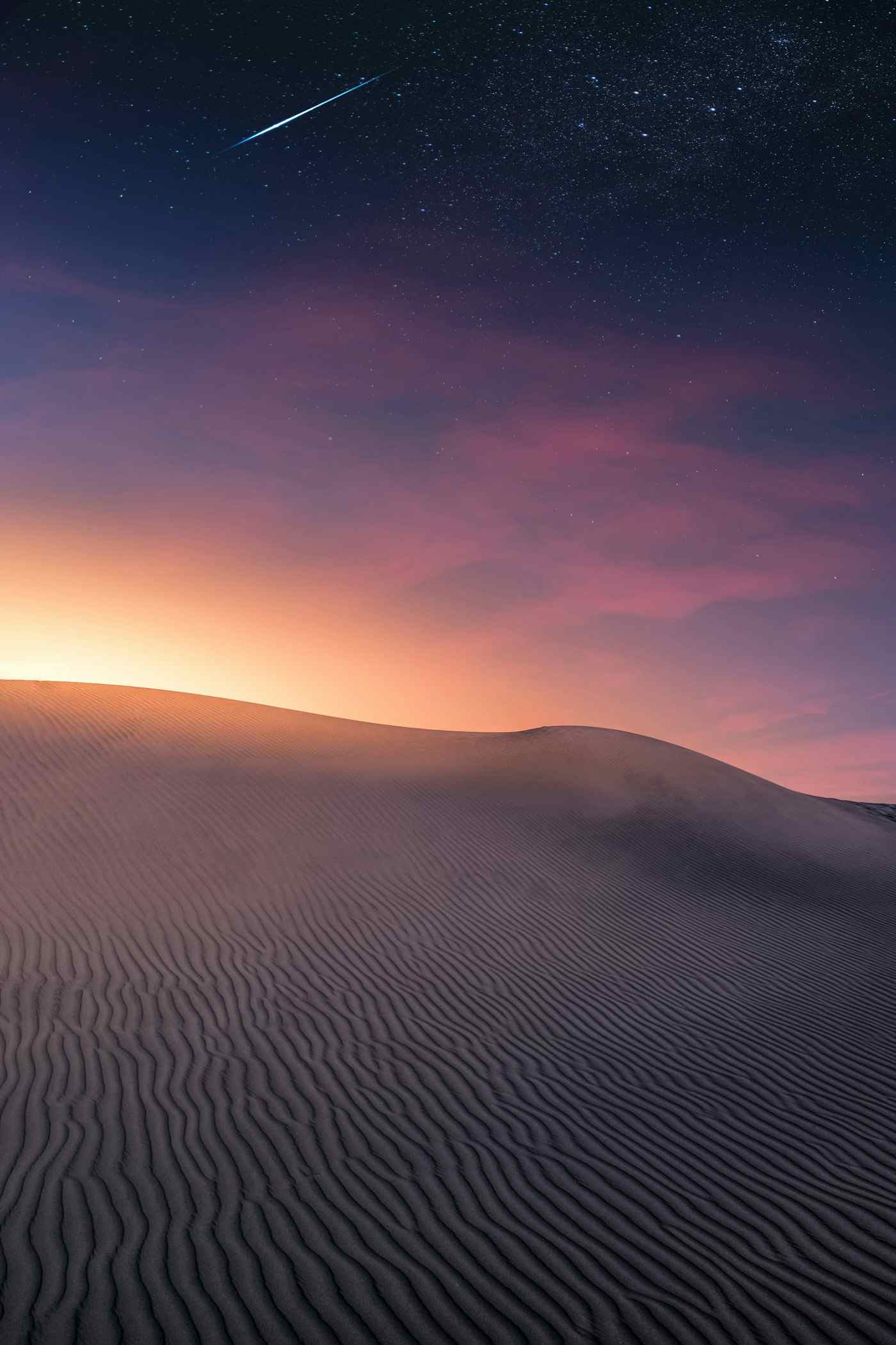 [Work title] by Asila: a dune at dusk under a streak of light