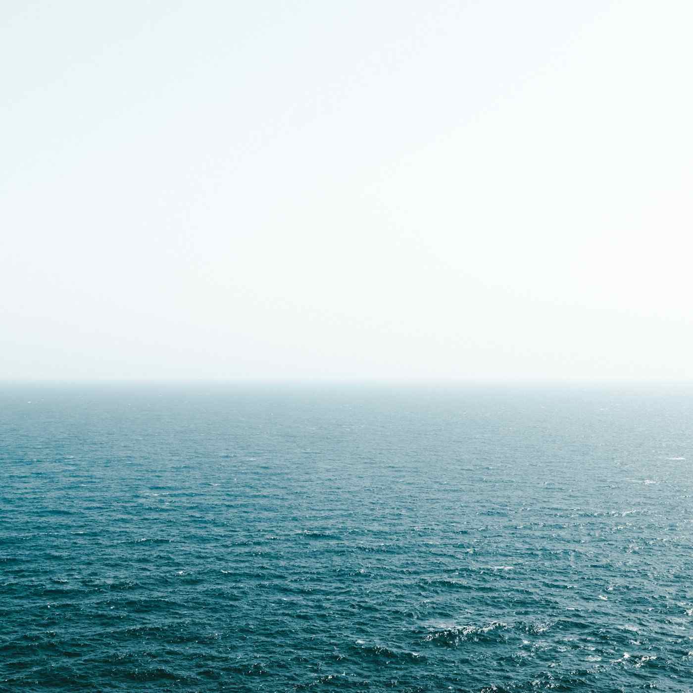 Calm sea meeting a pale sky