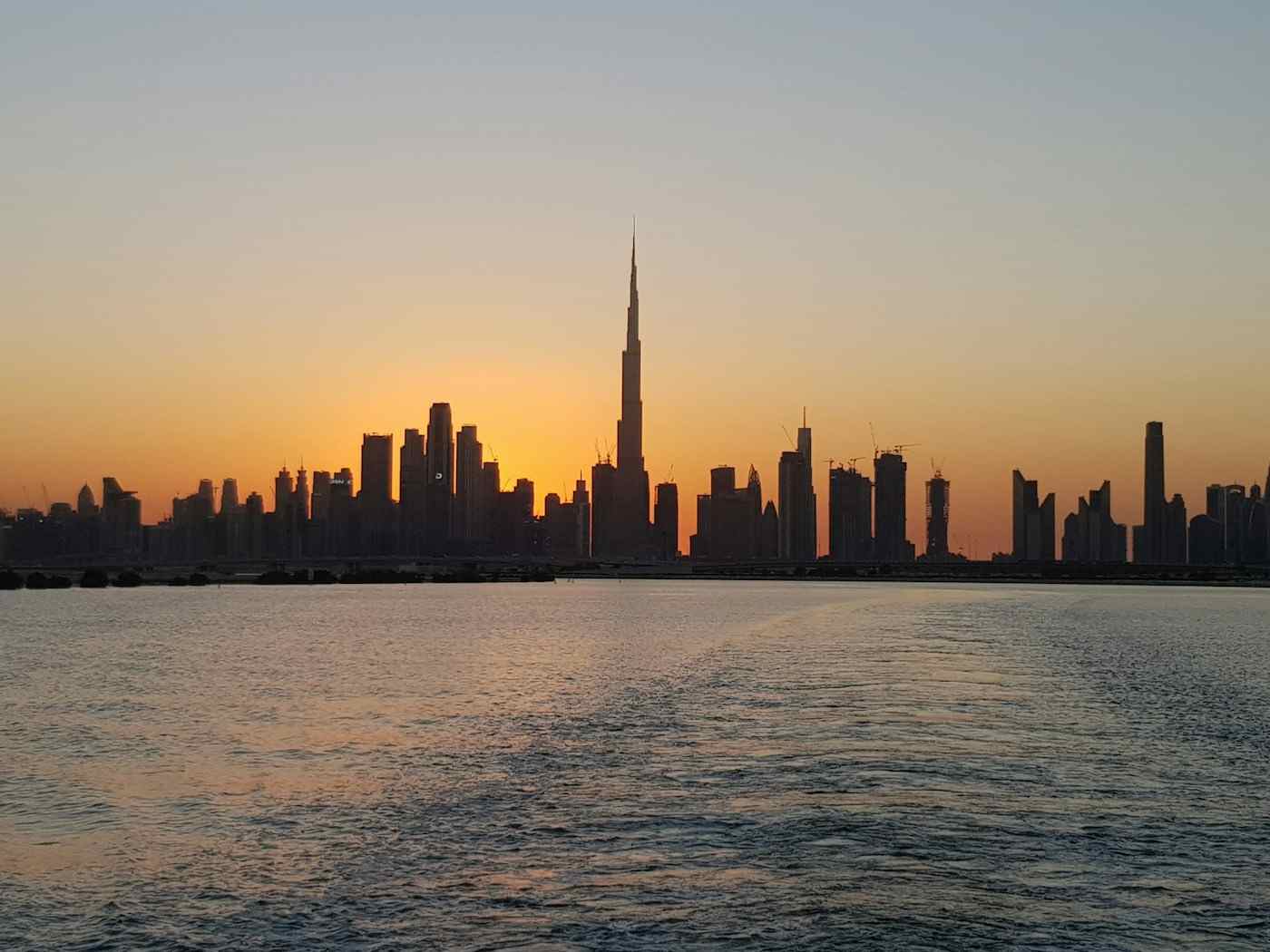 Dubai skyline at sunset across the water